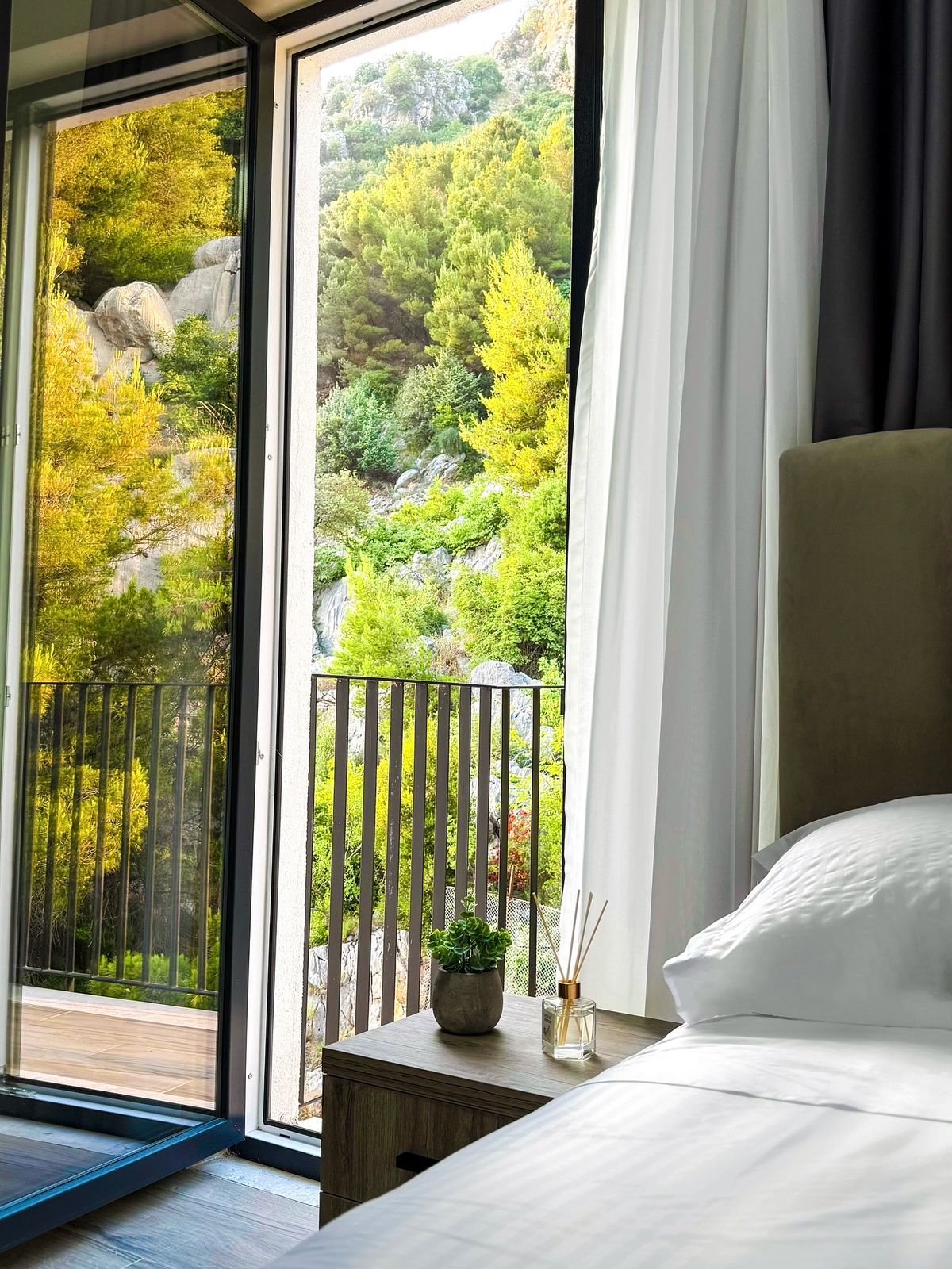 Green hillside view from a Villa Blanc room